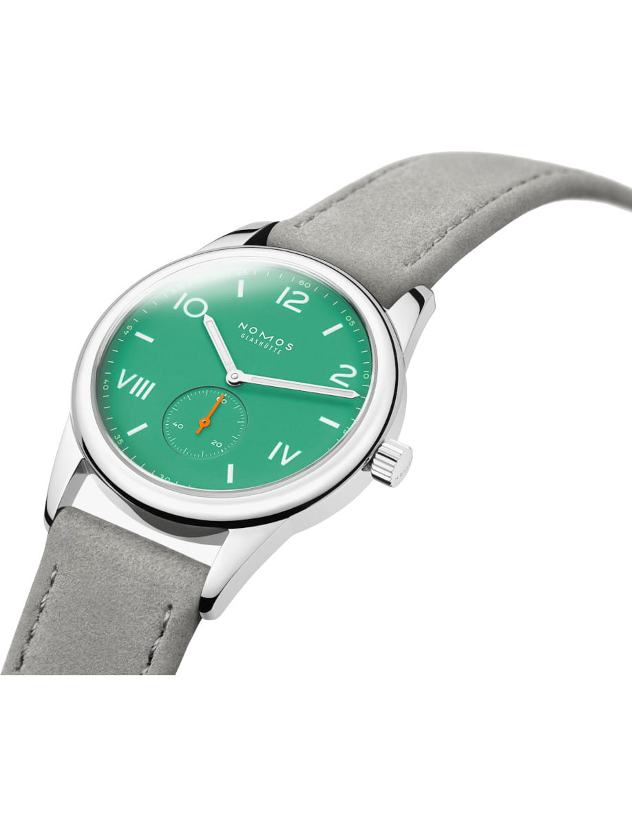 NOMOS Glashütte wristwatch with a green dial and gray strap, photographed at an angle.
