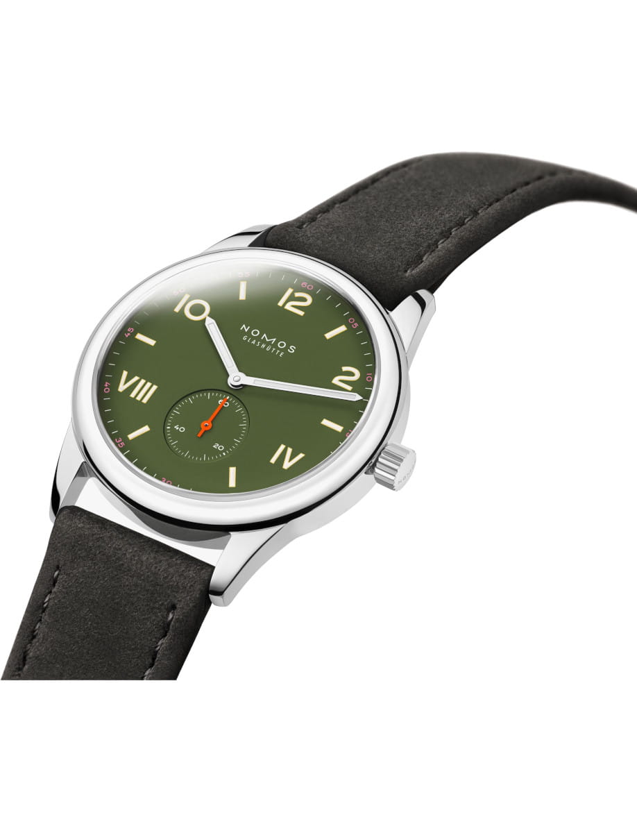 Side view of NOMOS Glashütte wristwatch with and green dial, silver case, and black leather strap.