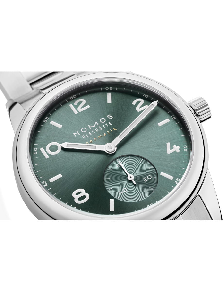 Side view of NOMOS Glashütte wristwatch with stainless steel case and bracelet, and petrol green dial.