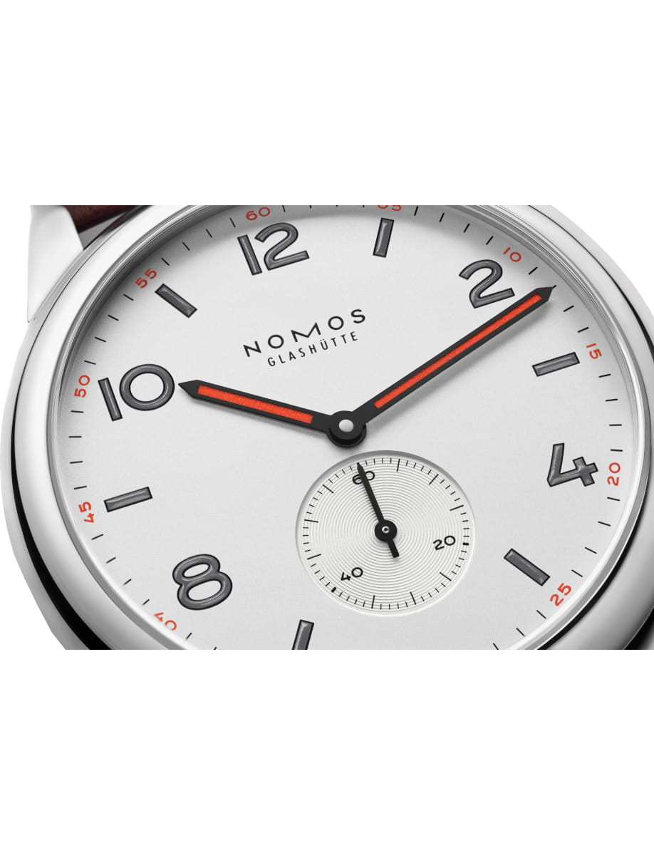 Close-up of a Nomos Club wristwatch with stainless steel case.