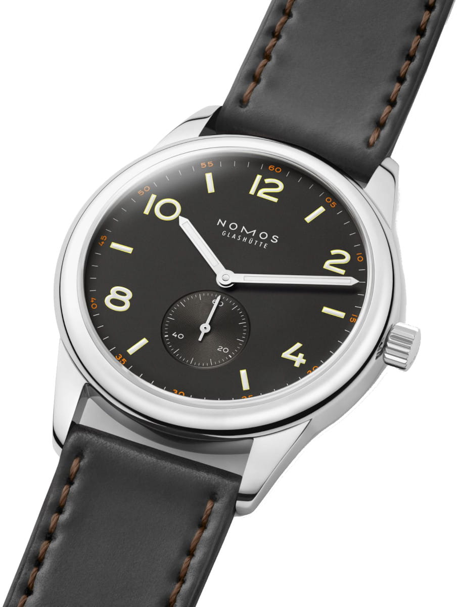 Close-up of a Nomos Club wristwatch with stainless steel case, Horween Genuine Shell Cordovan black strap with brown stitching, and black dial.