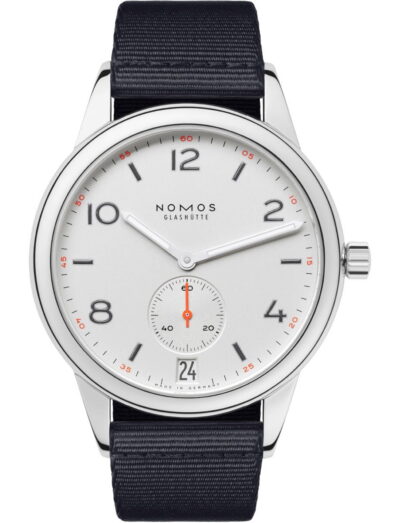 Nomos Glashütte wristwatch with white dial, black Arabic numerals, date window at 6, and navy fabric strap.