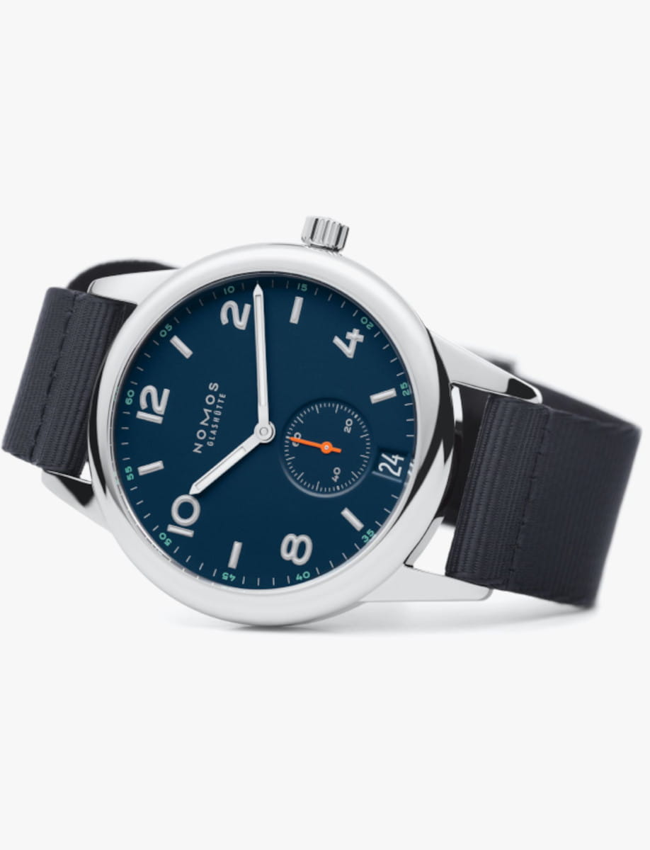 Side view of Nomos Club wristwatch with stainless steel case, blue-black textile strap, and atlantic blue dial.