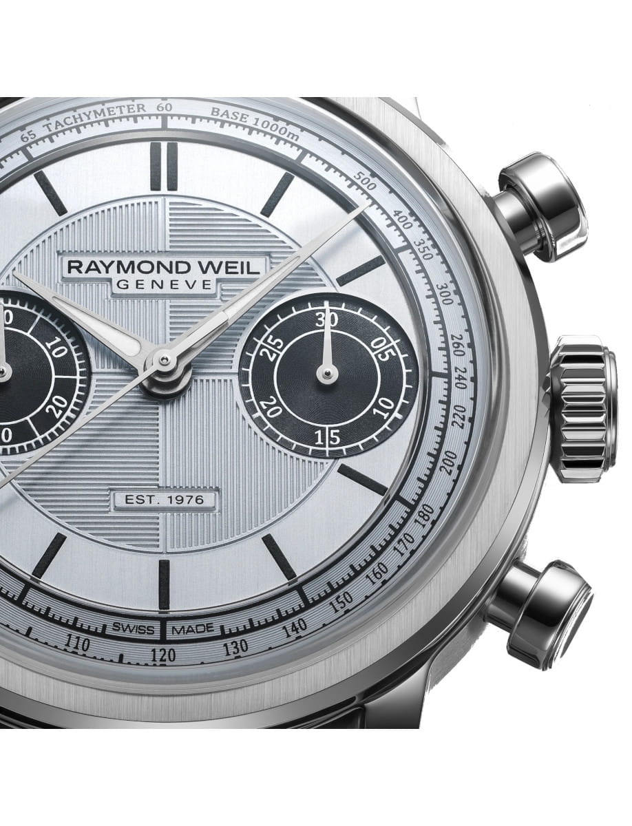 Close-up of a Raymond Weil Genève chronograph wristwatch with a stainless steel case, light blue dial, and black subdials.