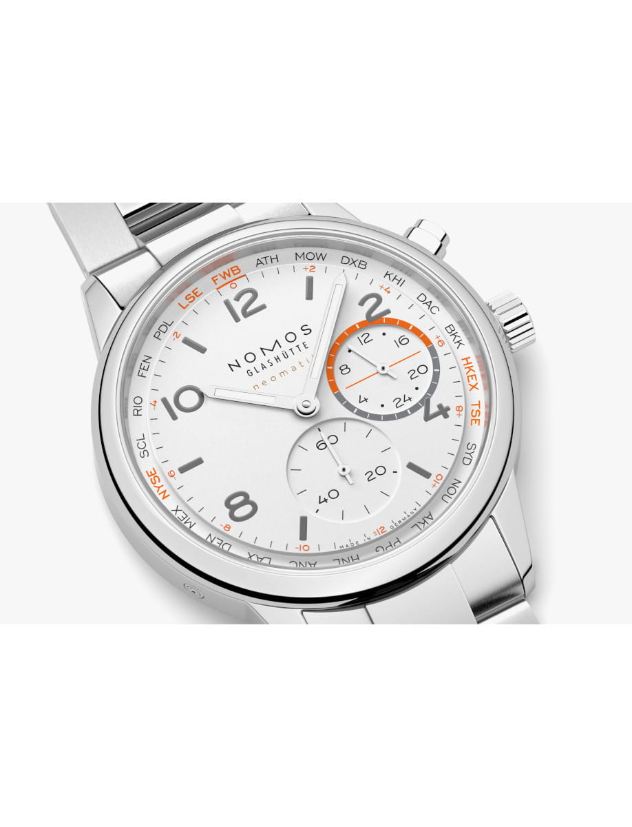 Close-up of a silver Nomos Glashütte wristwatch with white dial, black numerals, and orange accents on the subdial and bezel edge