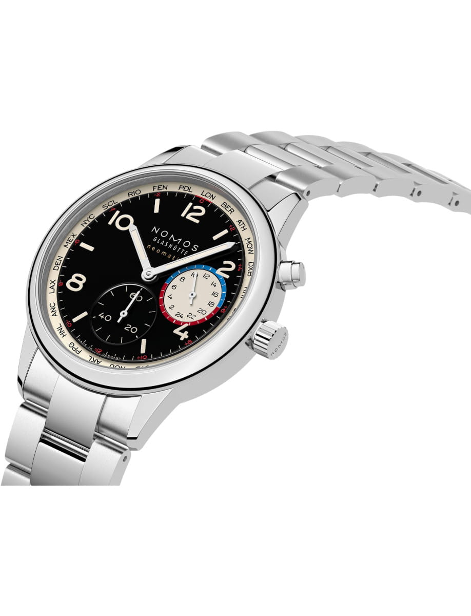 Nomos stainless steel wristwatch with a black dial, three subdials, and a polished metal bracelet. The bezel shows world city codes, and the brand NOMOS GLASHÜTTE is visible on the dial.