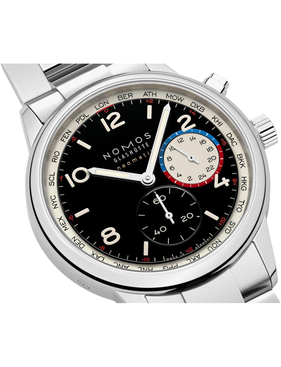 Close-up of a Nomos Glashütte neomatik world-time wristwatch with a black dial, steel case, and a multicolor 24-hour subdial at 3 o'clock area.