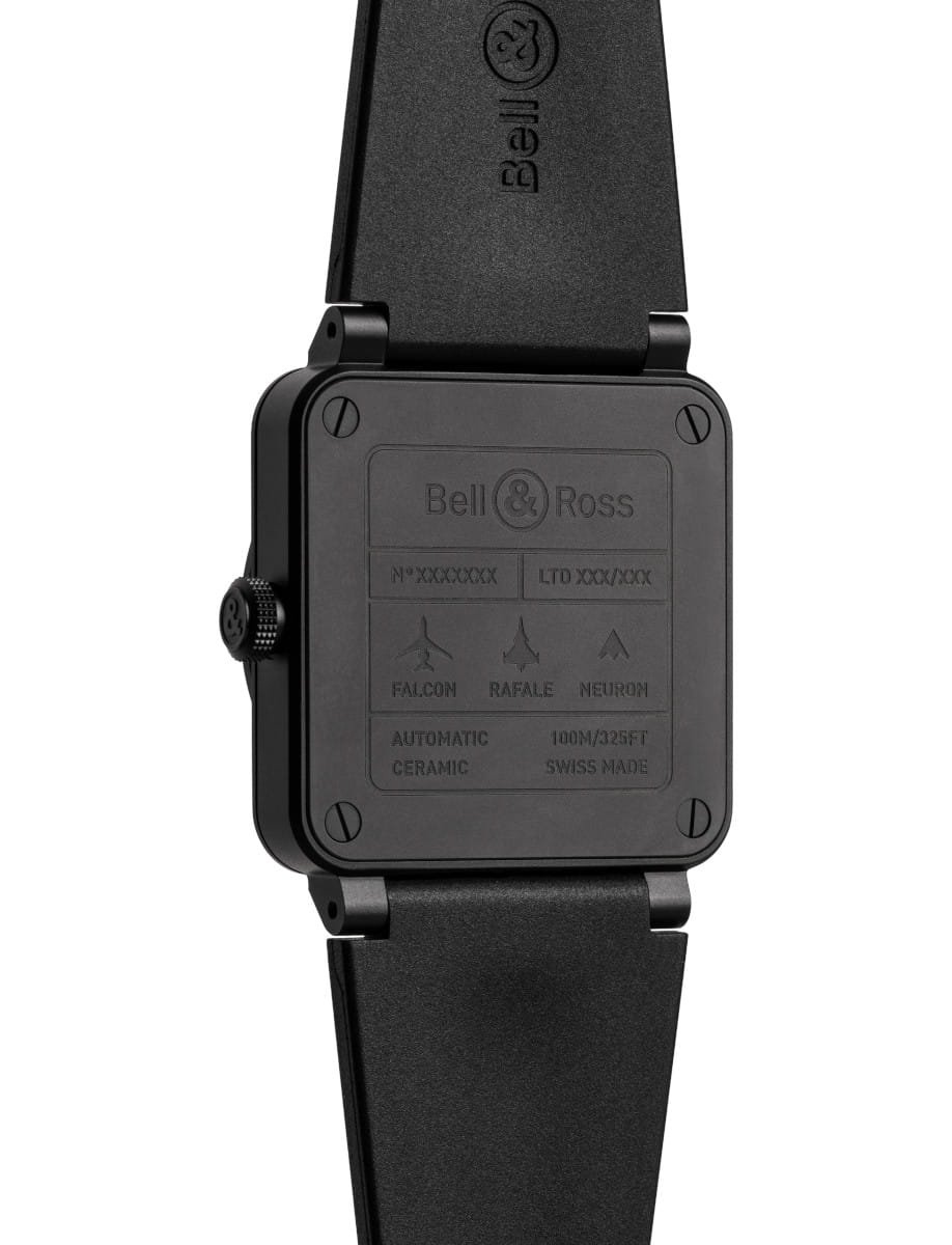 Back of a Bell & Ross watch with a black ceramic case, visible screws, and a black rubber strap