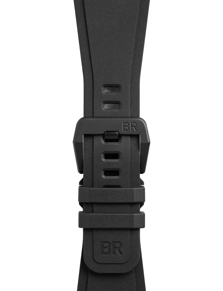 Close-up of a black rubber watch strap with a quick-release buckle and BR branding, showing adjustment holes and textured clasp area.