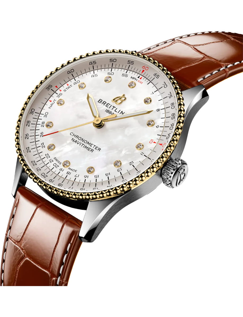 Side view of Breitling Navitimer Chronometer wristwatch with a 18k yellow gold and steel case, mother-of-pearl dial, and diamond hour markers with gold hands, and brown leather strap.