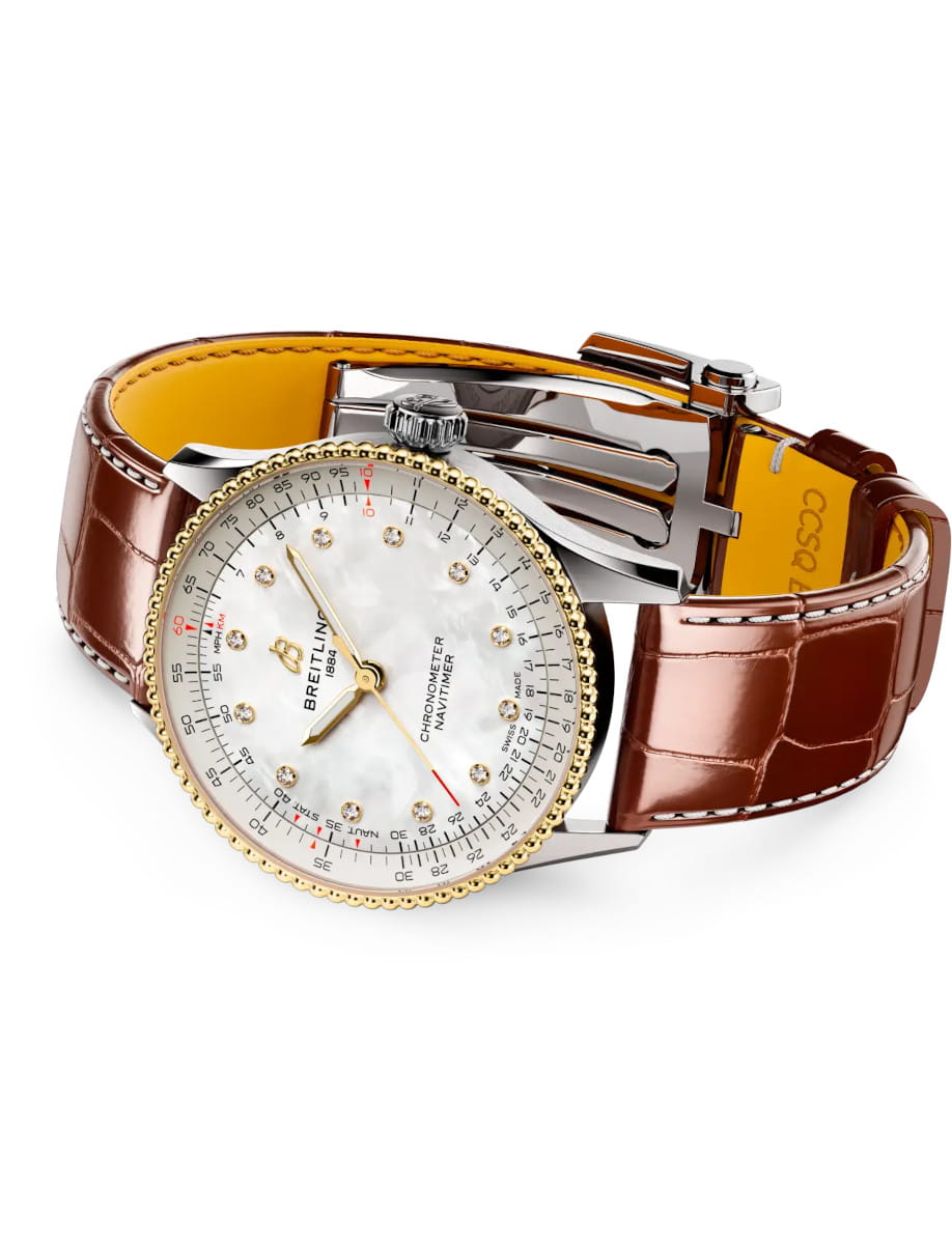 Side view of Breitling Navitimer Chronometer wristwatch with a 18k yellow gold and steel case, mother-of-pearl dial, and diamond hour markers with gold hands, and brown leather strap.