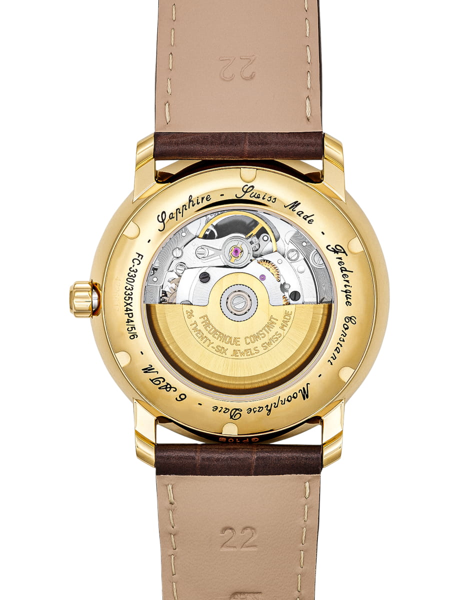Gold-toned wristwatch with a transparent caseback revealing the mechanical movement and rotor inside, attached to a brown leather strap with stitching