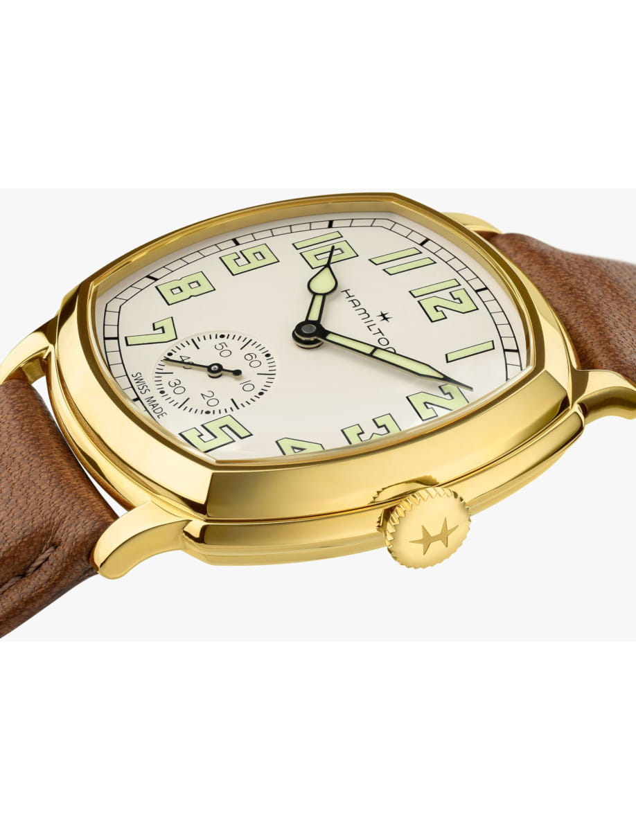 Gold-tone Hamilton wristwatch with cream dial and brown leather strap.