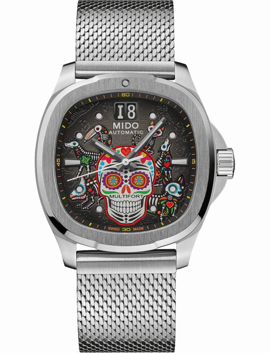 Stainless steel Mido automatic watch with a colorful skull dial and mesh band.