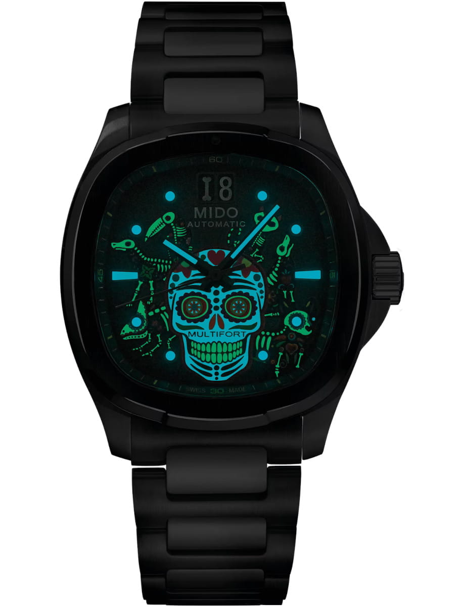 Mido wristwatch with stainless steel case and bracelet, and black gradient dial with colorful skull dial with luminescent markers and hands.