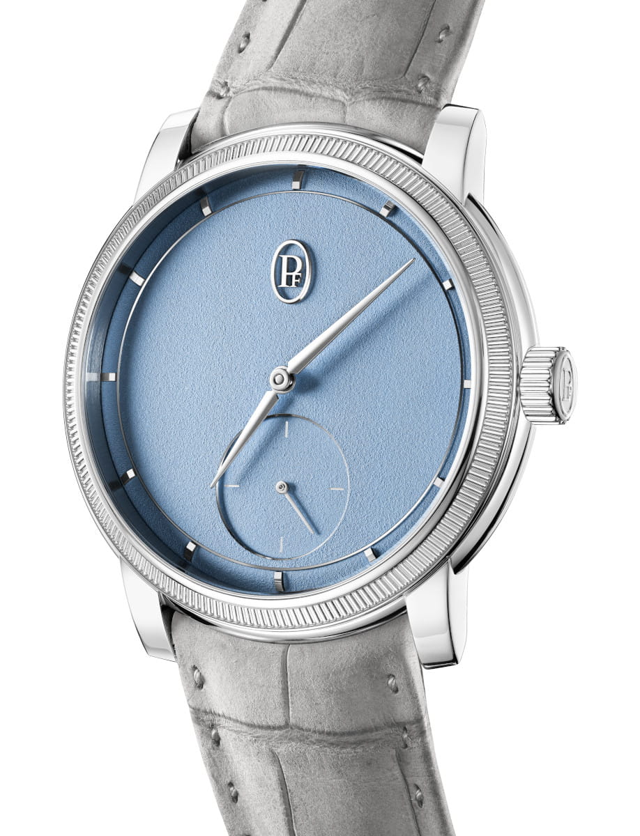 Close-up of Parmigiani Fleurier wristwatch with 950 Platinum case, blue dial, and Akoya Grey hand-stitched nubuck alligator leather strap.