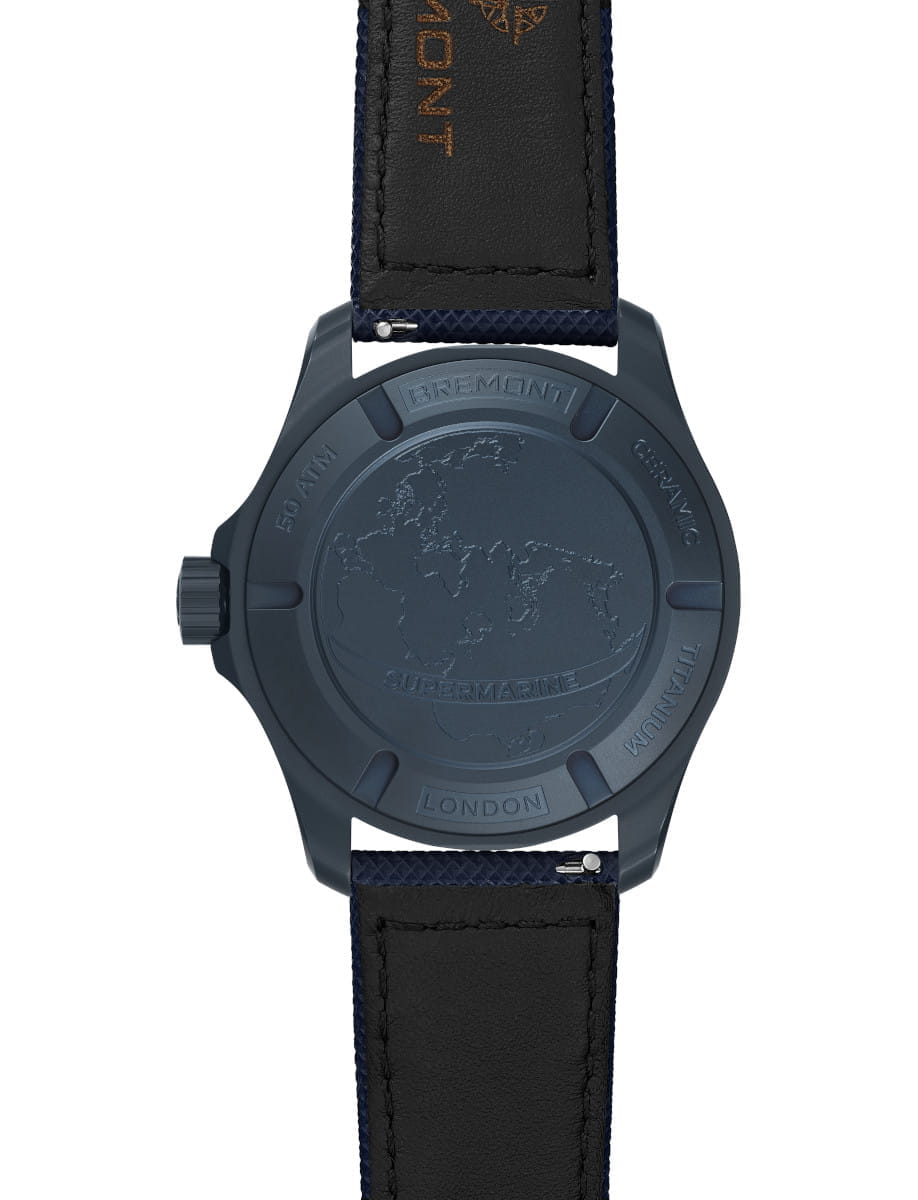 Blue watch case back with embossed world map, London inscription, and blue leather strap.