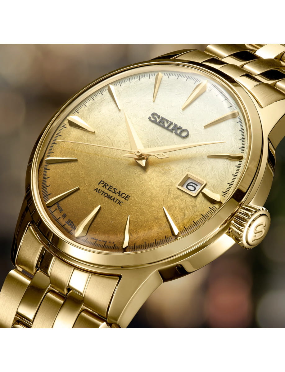 Gold tone Seiko Presage automatic watch close-up showing textured dial and date window at 3 o'clock