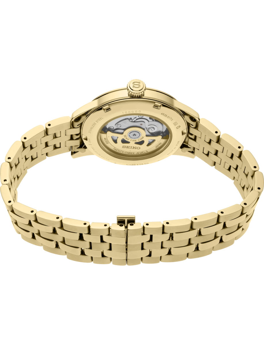 Seiko gold-toned stainless steel wristwatch with a transparent case back revealing the internal movement, linked bracelet and closed clasp.