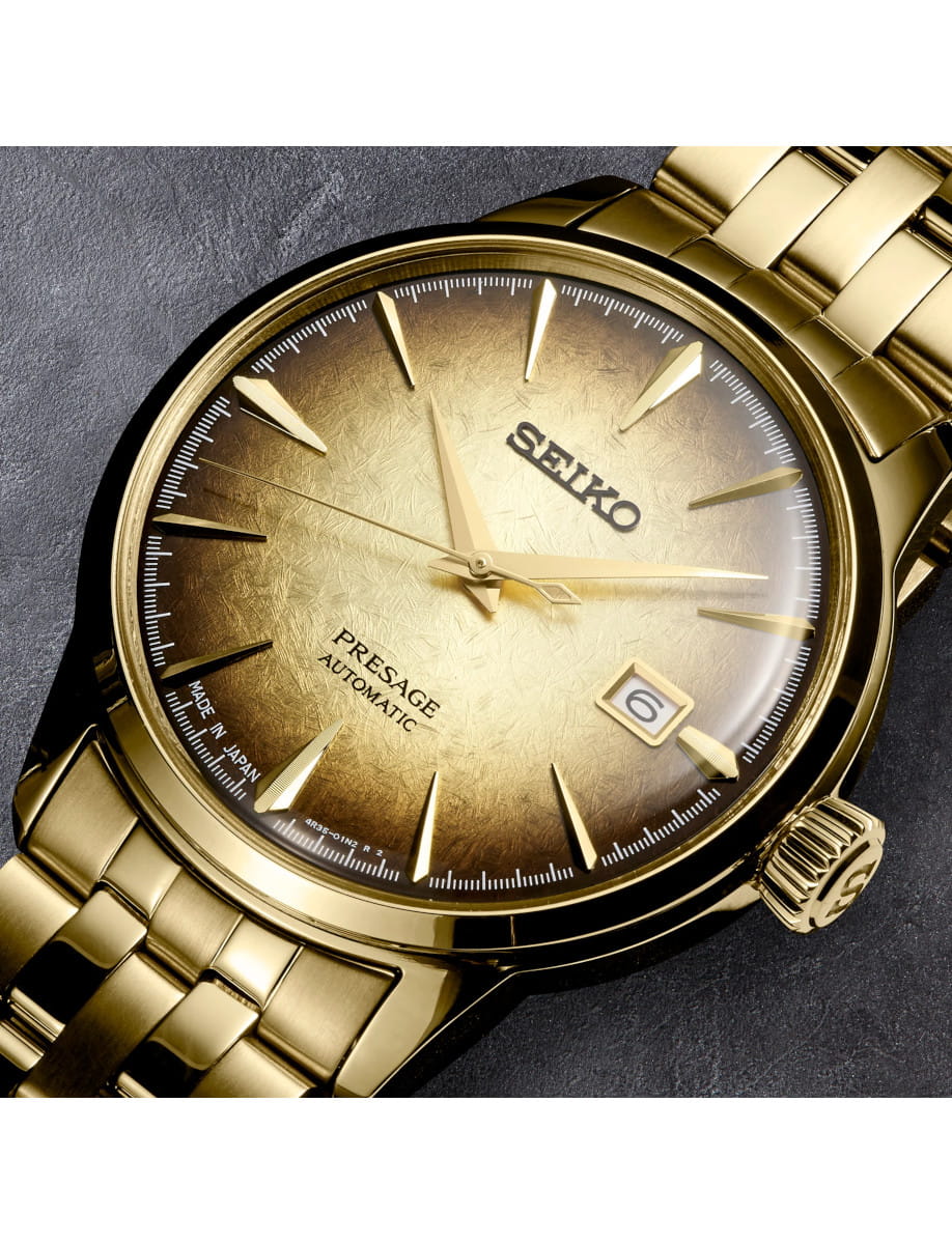 Close-up of a gold-toned Seiko Presage automatic wristwatch with a gradient brown dial and date window at 3 o'clock.