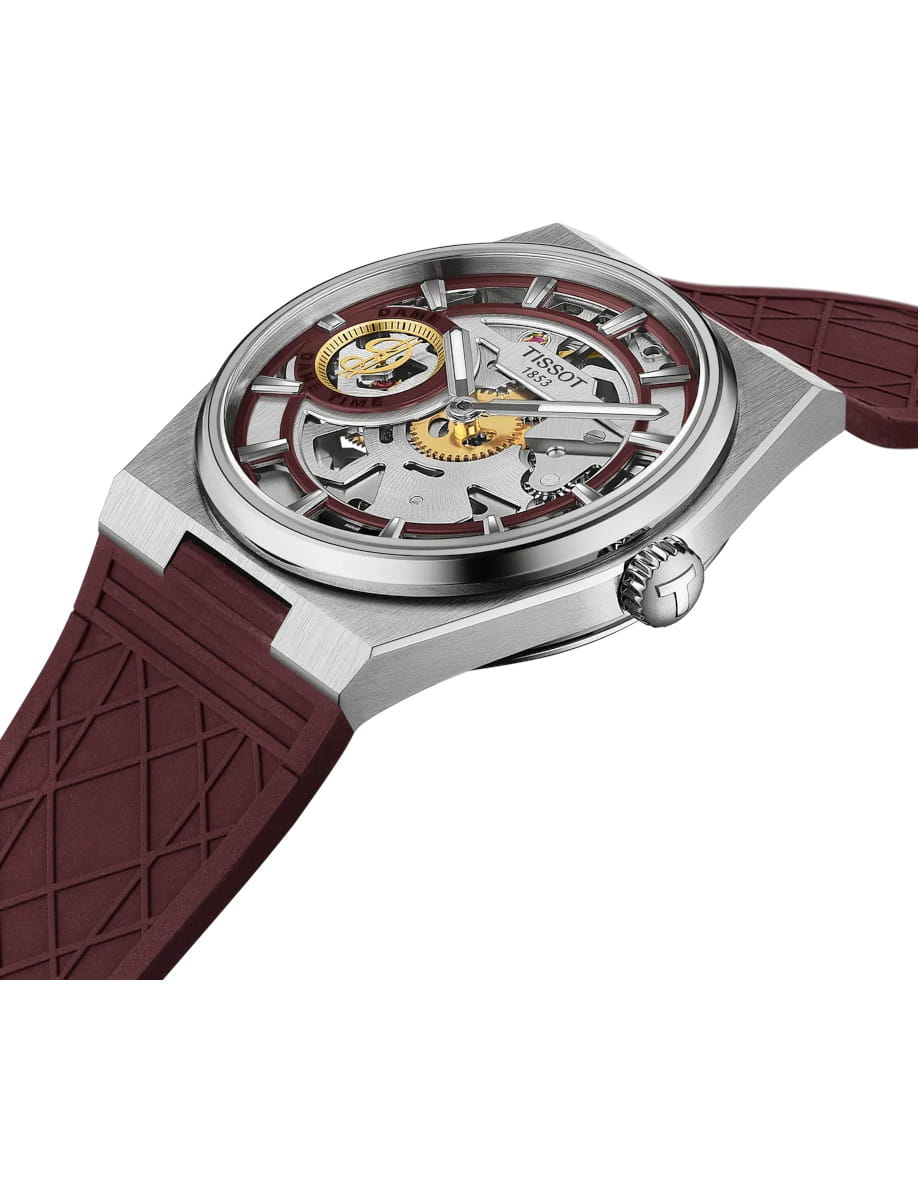Skeleton-style wristwatch with exposed gears, silver case and burgundy strap (Tissot).