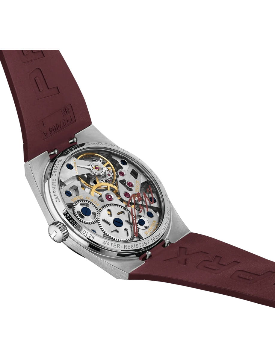 Stainless steel wristwatch with a transparent back showing gears and a burgundy rubber strap.