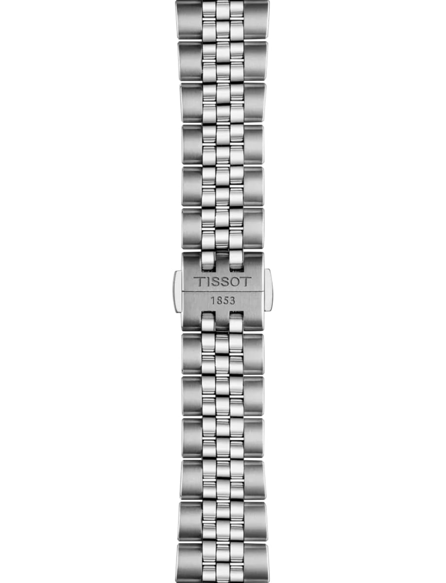 Close-up of a stainless steel Tissot watch bracelet clasp with 'TISSOT' and '1853' engraved on it