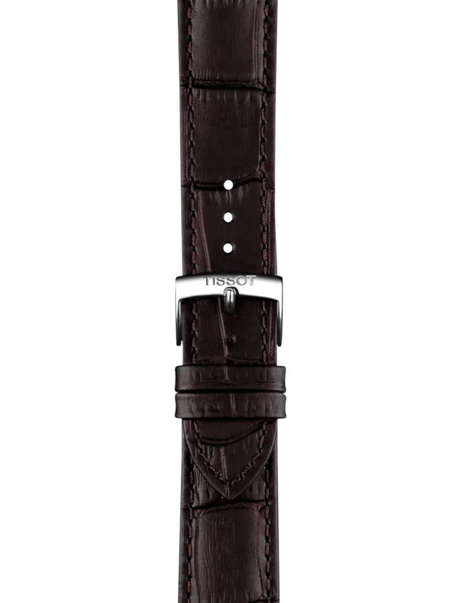 Brown leather watch strap with a silver Tissot buckle and stitched edges, shown from the front.