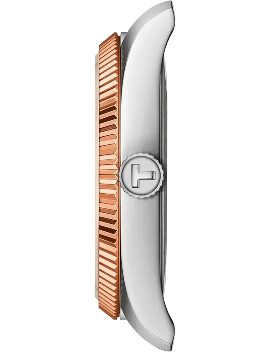 Side view of a silver wristwatch case with a copper knurled crown.