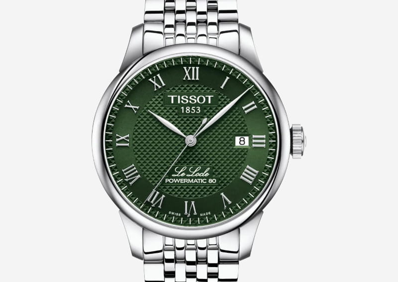 Green dial Tissot wristwatch with stainless steel bracelet, Roman numerals, date window at 3 o'clock, branding 'TISSOT 1853' and 'Le Locle Powermatic 80' visible
